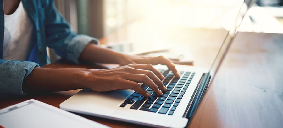 person typing on a laptop