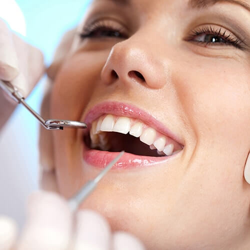 woman getting her teeth examined