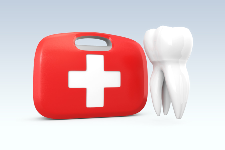 A red first aid kit next to a white tooth to indicate a dental emergency