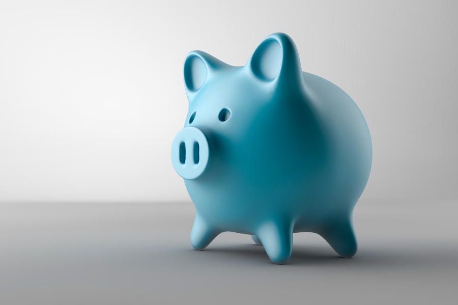Blue piggy bank against a gray background